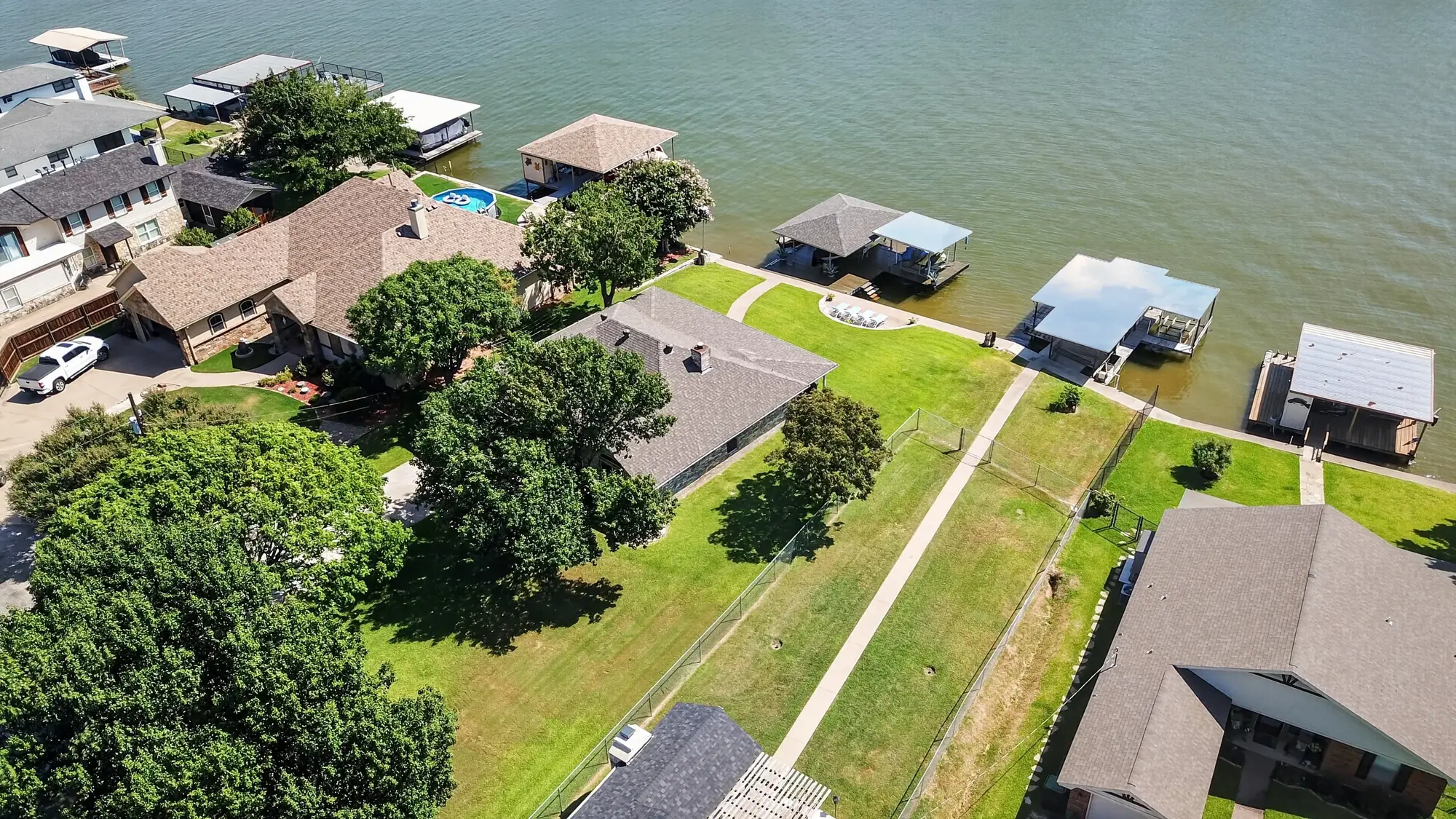 Aerial real estate photo of the Lake Granbury shoreline behind 1803 Chisec Court in Granbury Texas